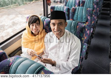 Muslim Couple Travel By Bus During Eid Mubarak Holiday