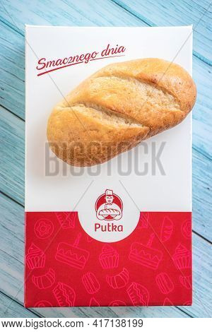 Lodz, Poland, 04.03.2021 Bread On A Box With The Logo Of The Polish Bakery Pulka On A Wooden Backgro