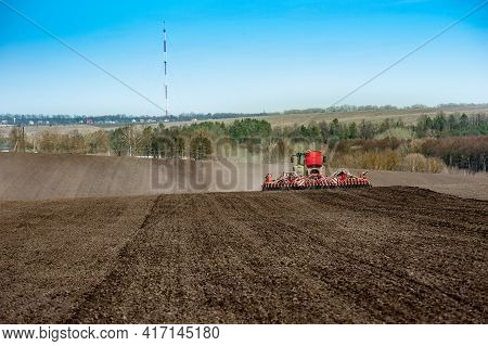 Baykivtsi, Ternopil Region, Ukraine - April 10, 2021: Farmers Sow On Prepared Arable Land, Apply Fer
