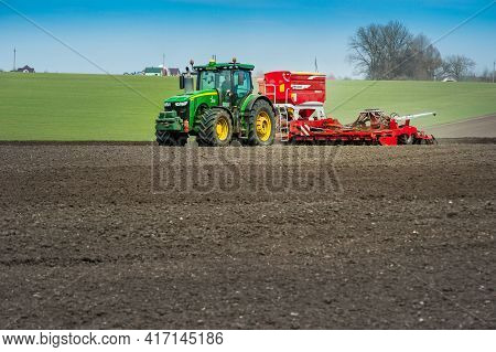 Baykivtsi, Ternopil Region, Ukraine - April 10, 2021: John Deere 8370R Tractor With A Pottinger Terr