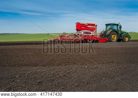 Baykivtsi, Ternopil Region, Ukraine - April 10, 2021: John Deere 8370R Tractor With A Pottinger Terr