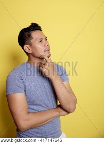 Casual Young Man Smile Thinking Idea With Holding The Chin And One Hand On Stomach
