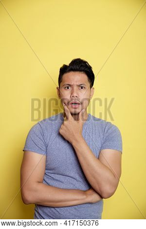 Casual Young Man Smile Thinking Idea With Holding The Chin And One Hand On Stomach