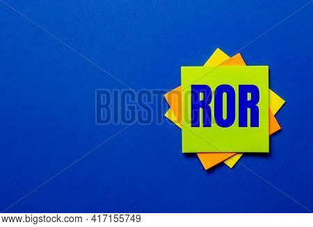 The Word Ror Is Written On Bright Stickers On A Blue Background
