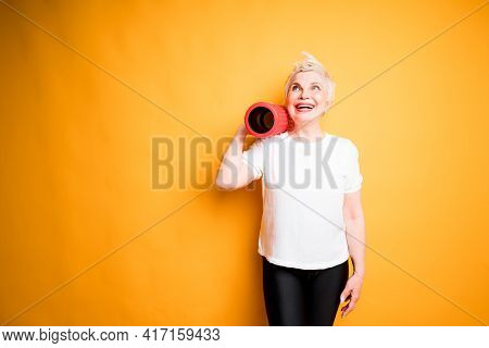 An Adult Woman Throwing A Faction On Her Shoulder And Holding It With One Hand Looks Up Looking Forw