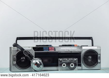 80s Retro Outdated Portable Stereo Radio Cassette Recorder, Headphones, Audio Cassette On  White Bac