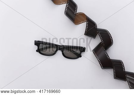 Film Tape And 3d Glasses On White Background. Сinema, Entertainment Industry. Top View