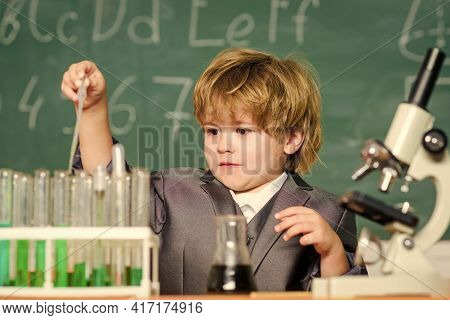 Kid Study Chemistry School Lesson. School Education. Boy Use Microscope And Test Tubes In School Cla