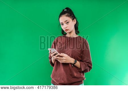 Portrait Beautiful Young Asian Girl Holding A Phone While Looking At The Camera