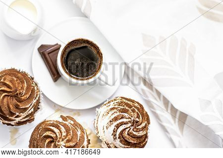 Dark Chocolate And Cocoa Chocolate Cupcakes With A Cup Of Hot Black Coffee. Space For Text
