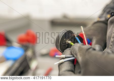 Wire Crimping Tool. Close-up Crimper. A Man Holds A Wire Crimper. Equipment For The Electrician. Cop