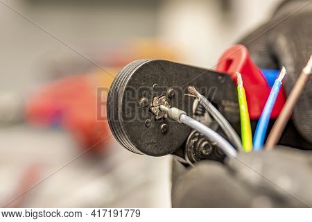 Wire Crimping Tool. Close-up Crimper. A Man Holds A Wire Crimper. Equipment For The Electrician. Cop