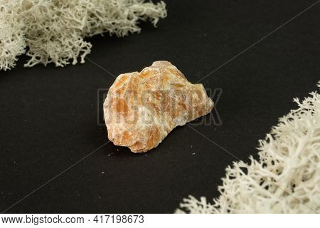 Orange Calcite From Brazil. Natural Mineral Stone On Black Background. Mineralogy, Geology, Magic Of