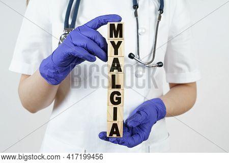 Medicine And Health Concept. The Doctor Holds Cubes In His Hands On Which It Is Written - Myalgia