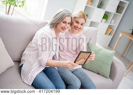 Photo Of Happy Nice Pretty Old Lady And Young Woman Sit Sofa Look Picture Nostalgia Family Indoors I