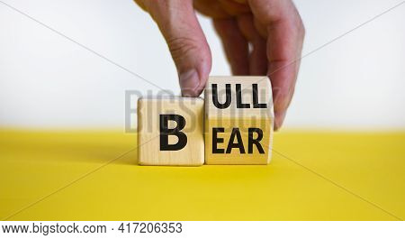 Symbol For A Positive Trend At The Stock Market. Businessman Hand Turns A Cube And Changes The Word 