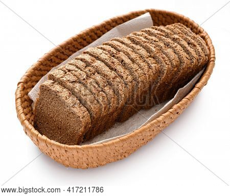sliced rye bread in a wicker basket, isolated on a white background