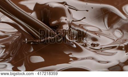 Splashing hot chocolate texture, close-up.