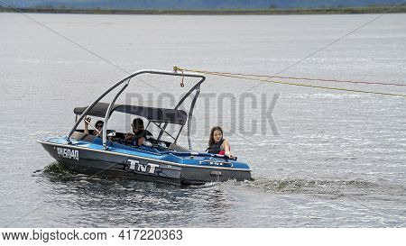 Mackay, Queensland, Australia - April 2021: A Power Boat Driven By Male With Two Female Passengers G