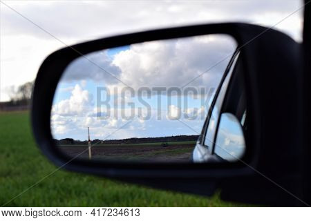 The Landscape Is Reflected In The Exterior Mirror Of A Car As A Monochron Image