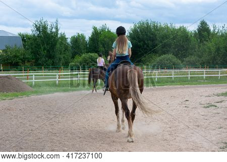 Young Caucasian Woman On Horse Back In Countryside. Horseback Riding As Hobby In Paddock On Woods. G