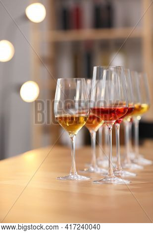 Different Sorts Of Wine In Glasses Prepared For Tasting On Wooden Table Indoors