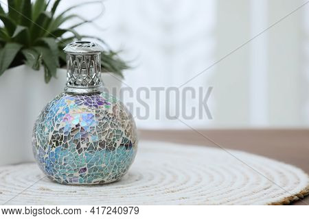 Burning Catalytic Purifying Lamp On Table, Space For Text