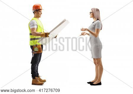 Full length profile shot of a contractor with a blueprint having a conversation with a woman isolated on white background