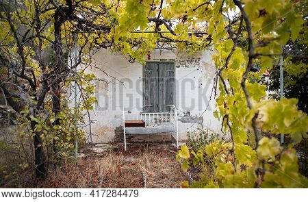 Old Baby Bed Against A Wall Of Abandoned Traditional House In Mediterranean Garden Framed With Yello