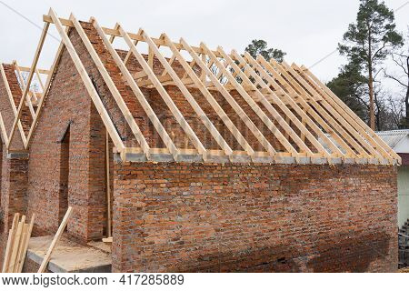 Installation Of Wooden Beams At Construction The Roof Truss System Of The Brick House. Mauerlat Lyin