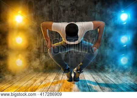 Hip Hop Dance. Young Man Break Dancer. Dancing In Stage Club Lights Smoke Over Grunge Floor And Wall