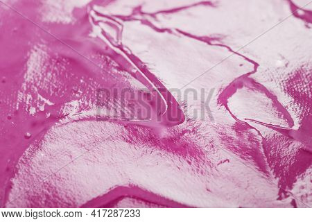 Transparent Liquid Gel On A Pink Background With Free Space.
