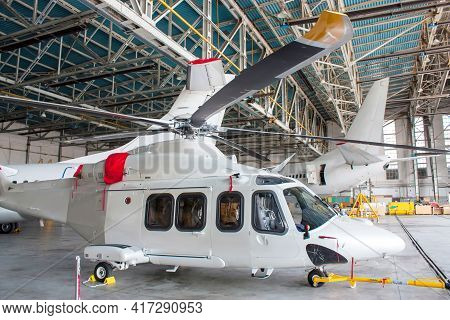 Passenger Helicopter And Airplanes Under Maintenance. Checking Mechanical Systems For Flight Operati