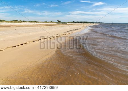 Sand And Lake With Blue Sky