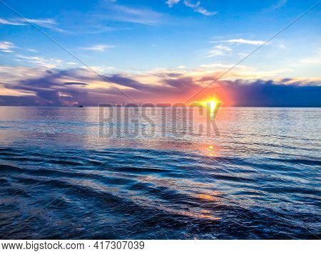 Blue, Orange And Purple Sunrise On The Ocean.