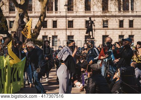 Westminster, London | Uk -  2021.04.17: Person With Microphone In Black Bandana Over Her Face Giving
