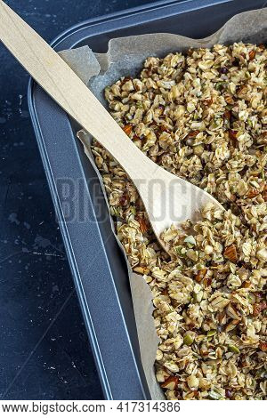 Raw Granola, Muesli From Oat Flakes, Varius Of Nuts, Honey, Pumpkin Seeds On Baking Sheet. Home Cook