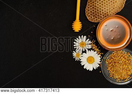 A Yellow Spoon Of Honey Dipped In A Jar Of Honey And Bee Bread Scattered On A Black Background Decor