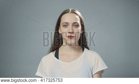 Photo Of Young Impudent Girl On Grey