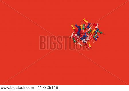 Heap Of Pushpins. Paperclip, Staple, Paperfastener On Red Background
