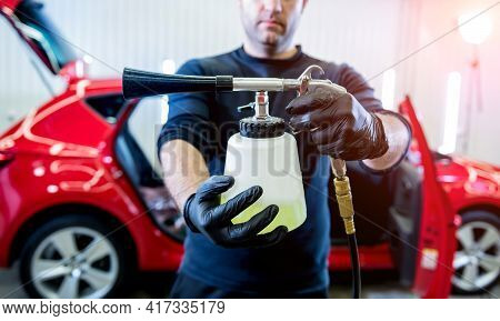 A Car Service Worker Cleans Interiror With A Special Foam Generator