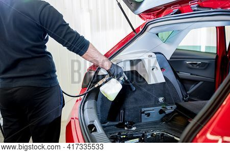A Car Service Worker Cleans Interiror With A Special Foam Generator