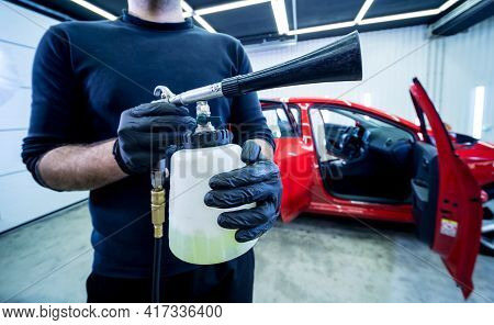 A Car Service Worker Cleans Interiror With A Special Foam Generator