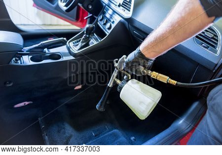 A Car Service Worker Cleans Interiror With A Special Foam Generator
