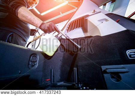 A Car Service Worker Cleans Interiror With A Special Foam Generator