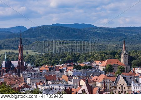 Walbrzych, Poland - June 15 2020: Cityscape Of City Buildings With Mountains At Background