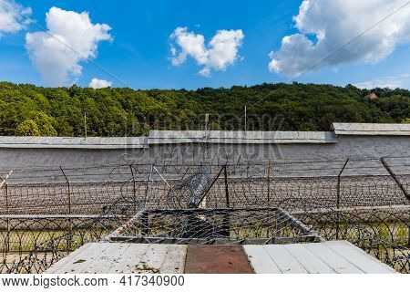 Walbrzych, Poland - June 15 2020: Heart Shape Cloud Over Trees Next To Fences Of Old Prison Custody
