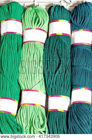 Rolls Of Polyester Cord In Various Vibrant Shades Of Green, Rolled. Vertical Image, Copy Space.
