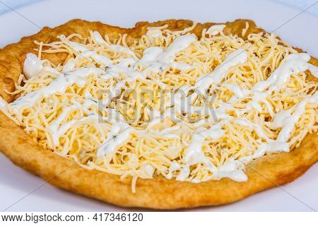 Langos Stuffed With Grated Cheese And Dressing.langos Is A Traditional Hungarian Food. Food Styling 