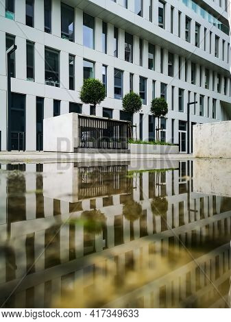 Wroclaw, Poland - June 7 2020: White High Corporate Building With Green And Concrete Square Around R